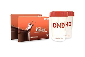 Two boxes of "RxLite" premium black cocoa drink with an illustration of a chocolate splash, next to two white shakers with red lids featuring the "DND" logo.